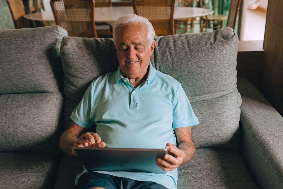 senior man smiling relaxed at home korean