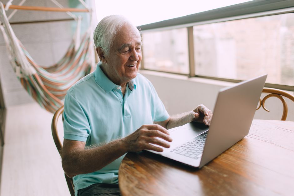 retired man using laptop for online tax filing