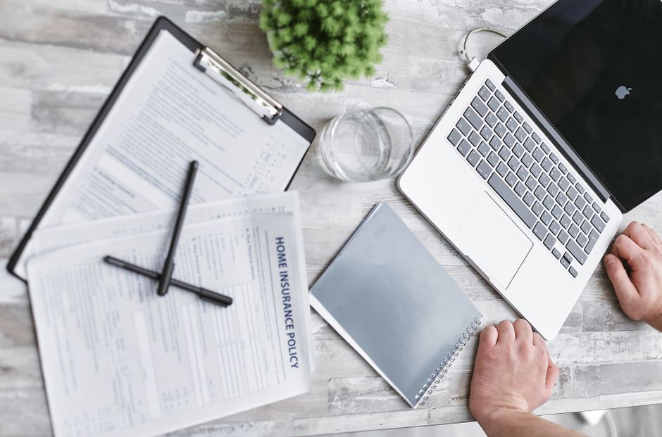 calculator and insurance policy paperwork