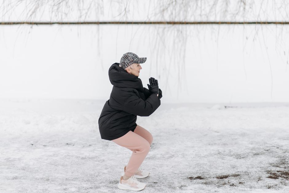 elderly person doing squat exercise home