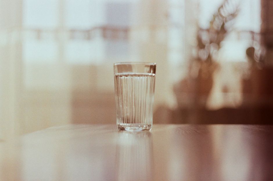 glass of water on table sunny window