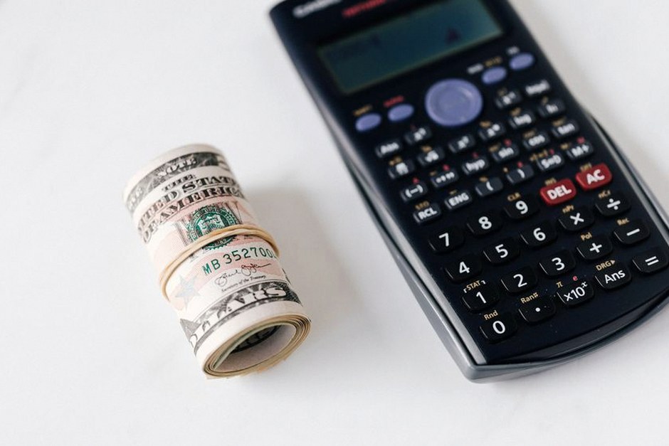 calculator and savings passbook on table