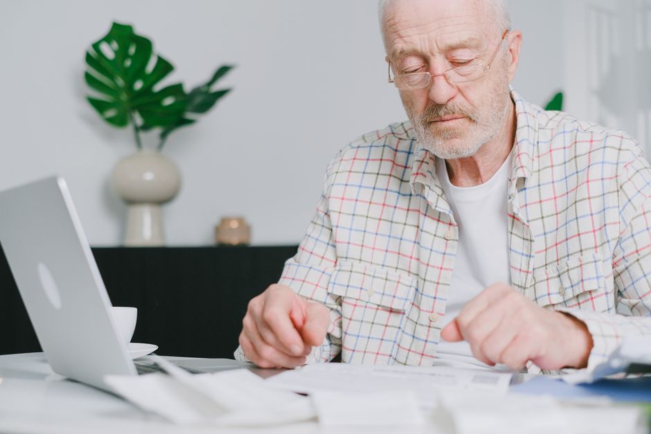 happy retired person reviewing finances at home
