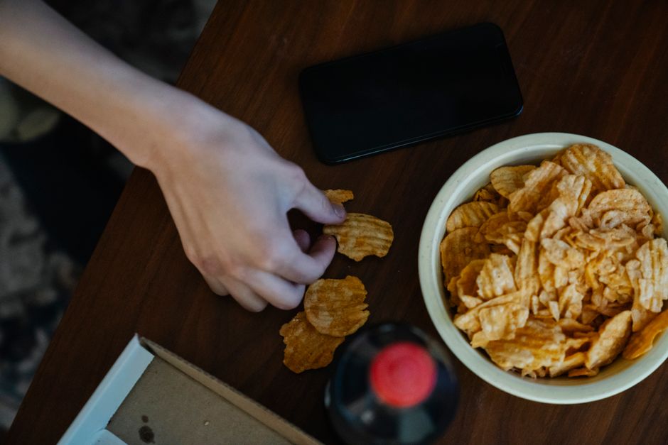 soda and salty snacks on table