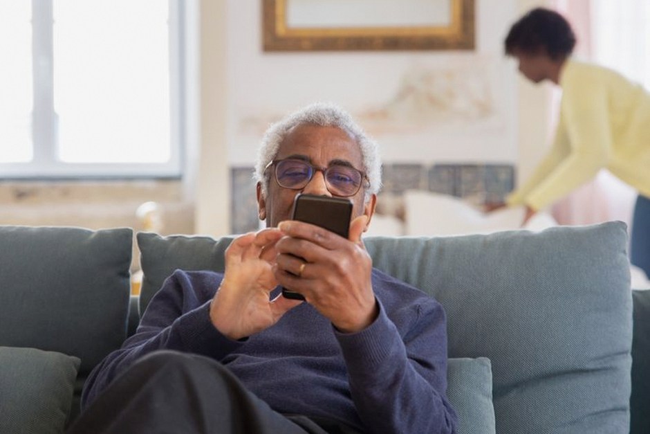 senior citizen using phone application housing
