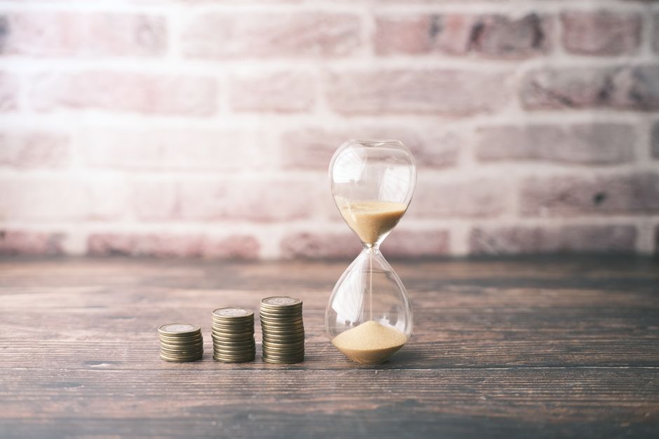 hourglass with money planning concept