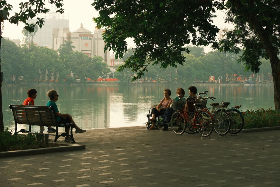 korean seniors resting in shade park summer