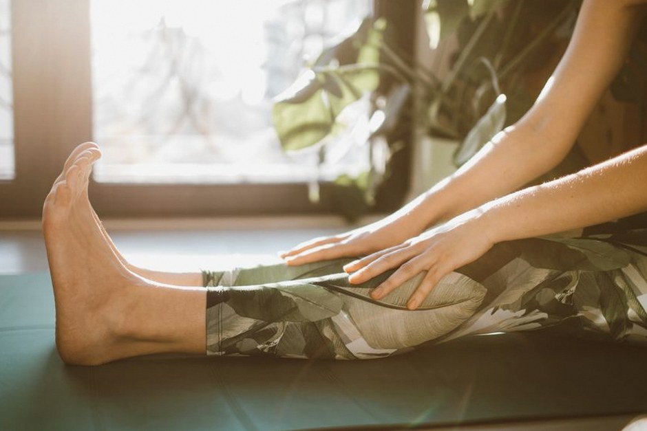 person stretching legs while seated