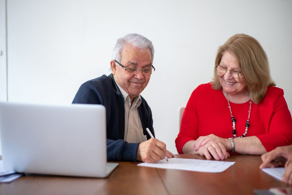 happy korean retired couple planning finances