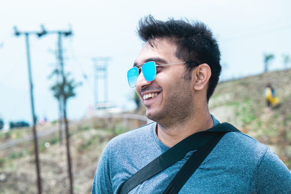 person wearing sunglasses outdoors happy