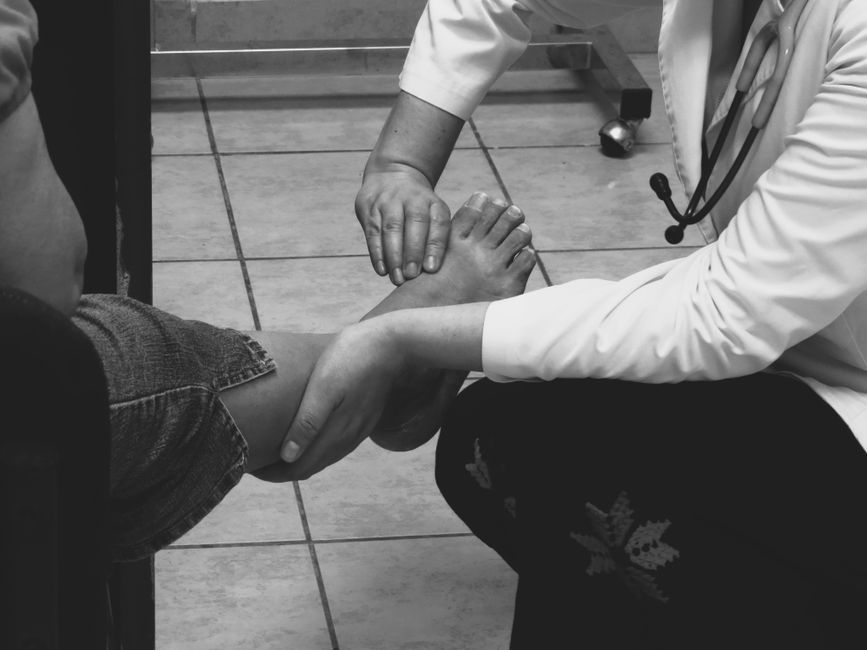 doctor examining patient foot clinic