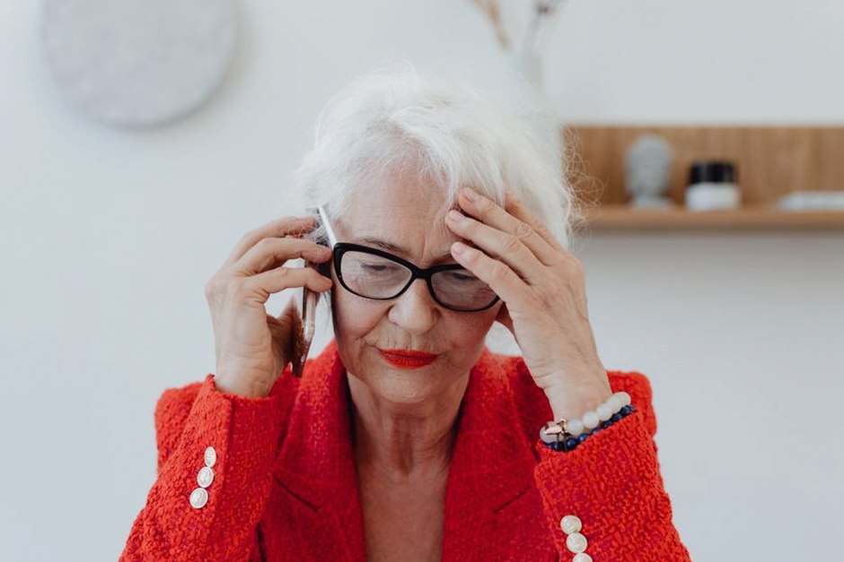 elderly korean person on phone worried