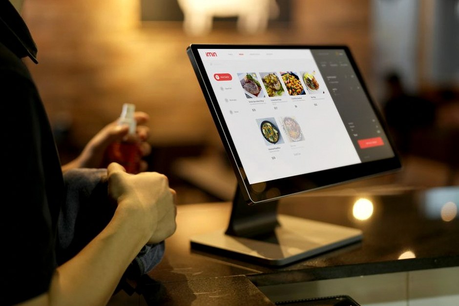elderly person using self-service kiosk restaurant