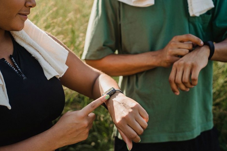 person checking smartwatch health data outdoors