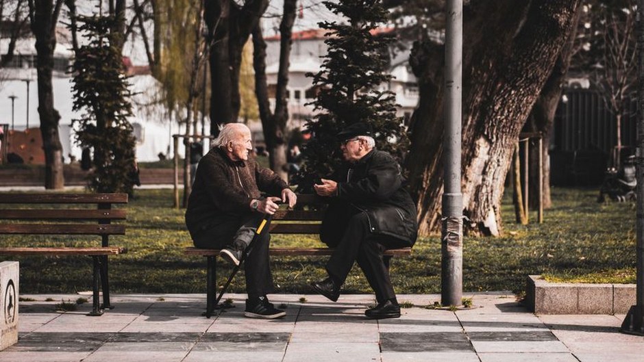 elderly korean people talking park bench