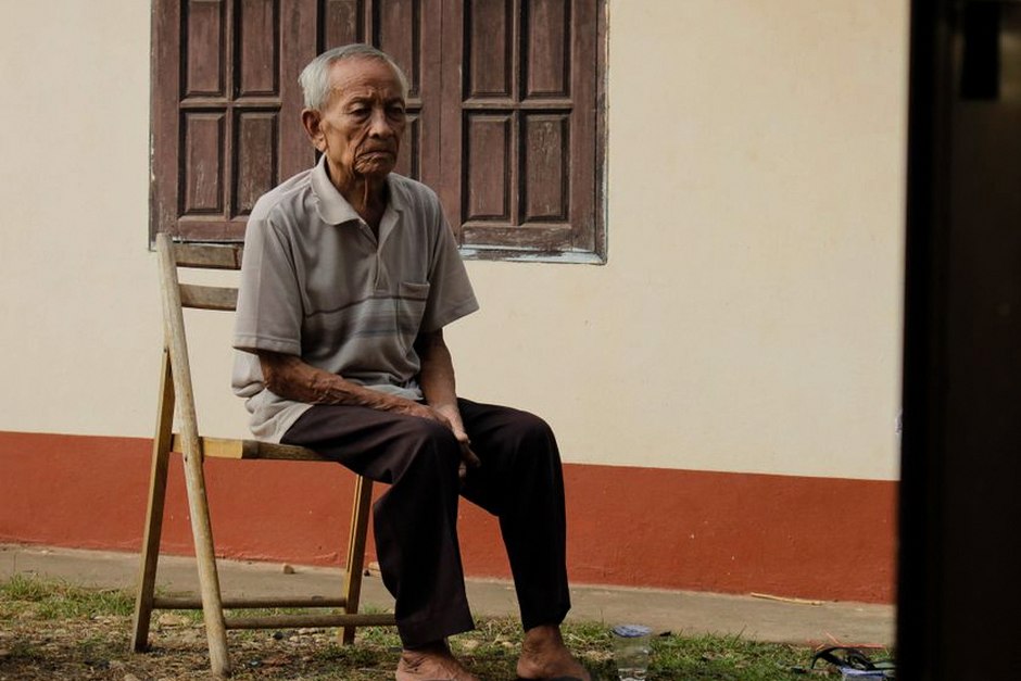 elderly korean man sitting alone window