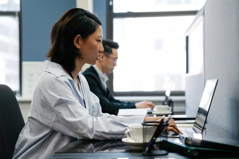 korean office worker checking retirement savings on laptop