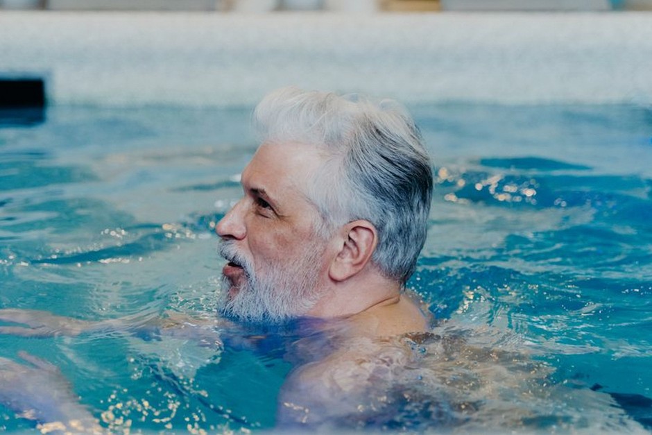 senior man swimming pool exercise