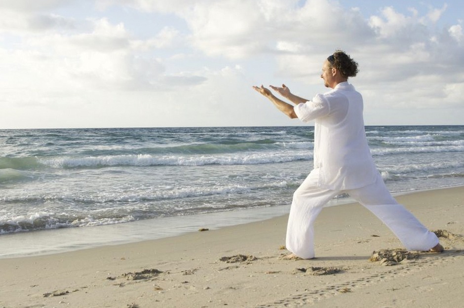 senior woman practicing tai chi outdoors morning