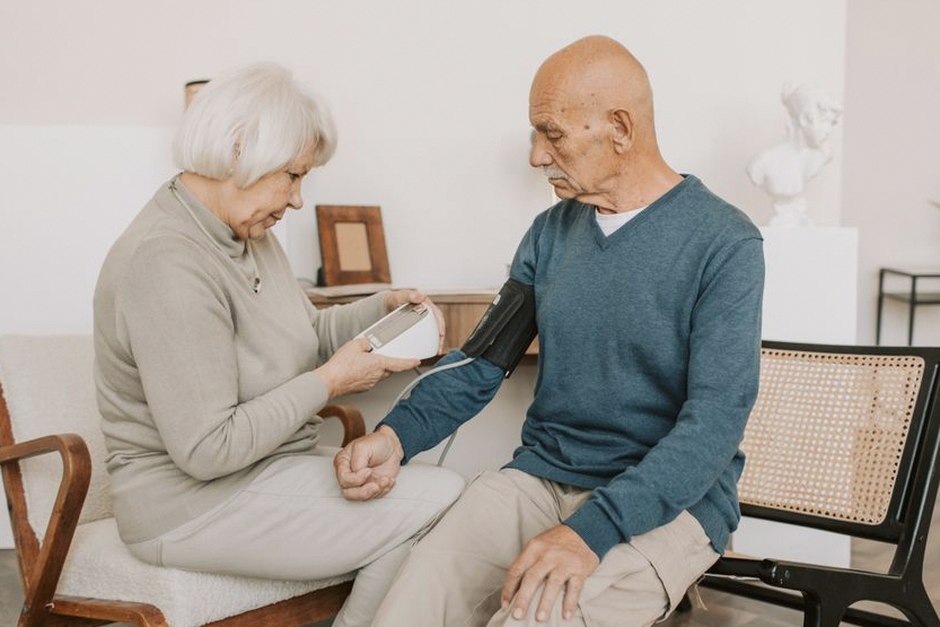 senior citizen taking blood pressure medication