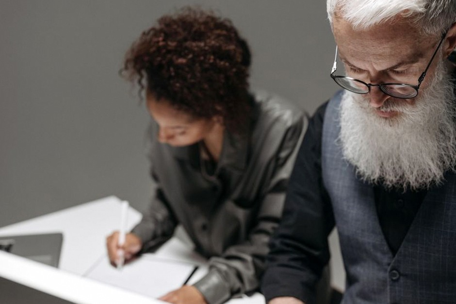 elderly man writing will document at desk