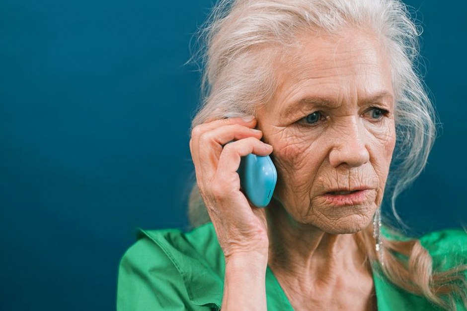 senior woman calling taxi with phone