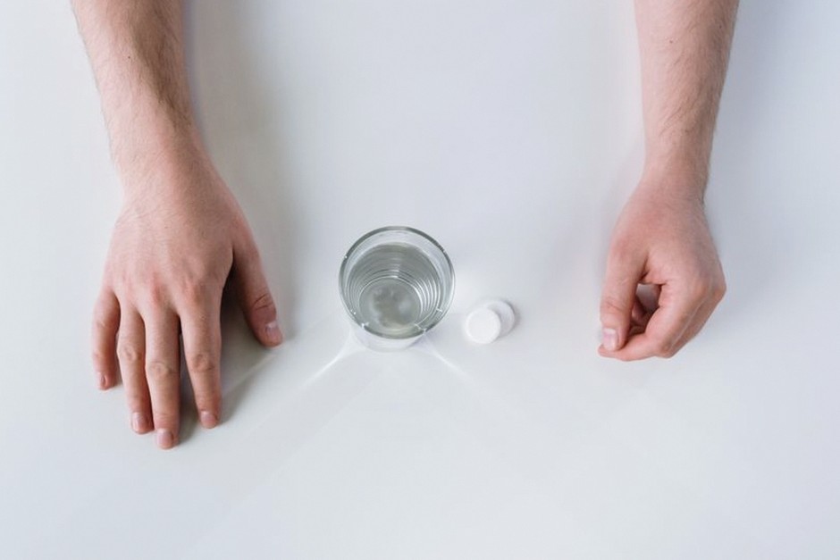 denture cleaning tablet soaking in water glass