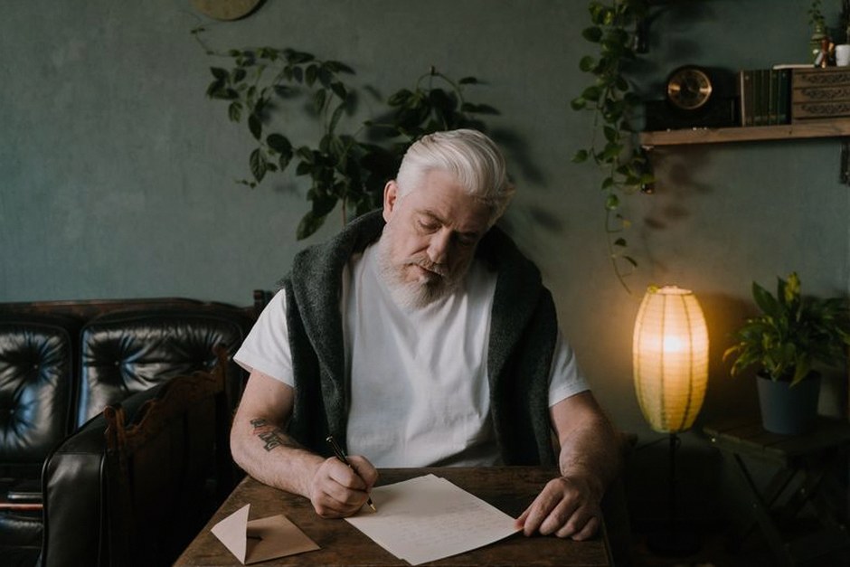 elderly person writing handwritten letter