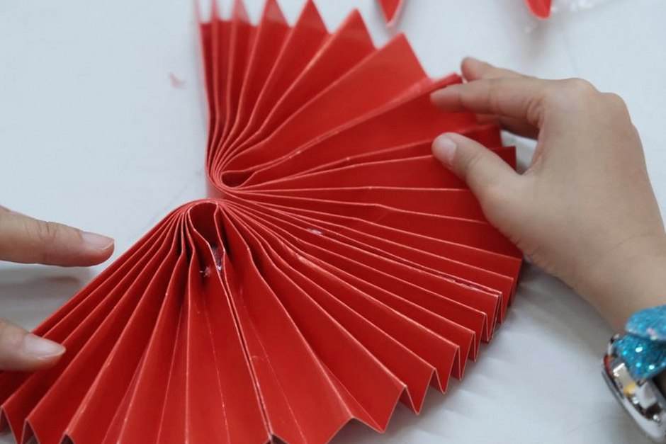 grandmother and grandchild doing paper folding origami