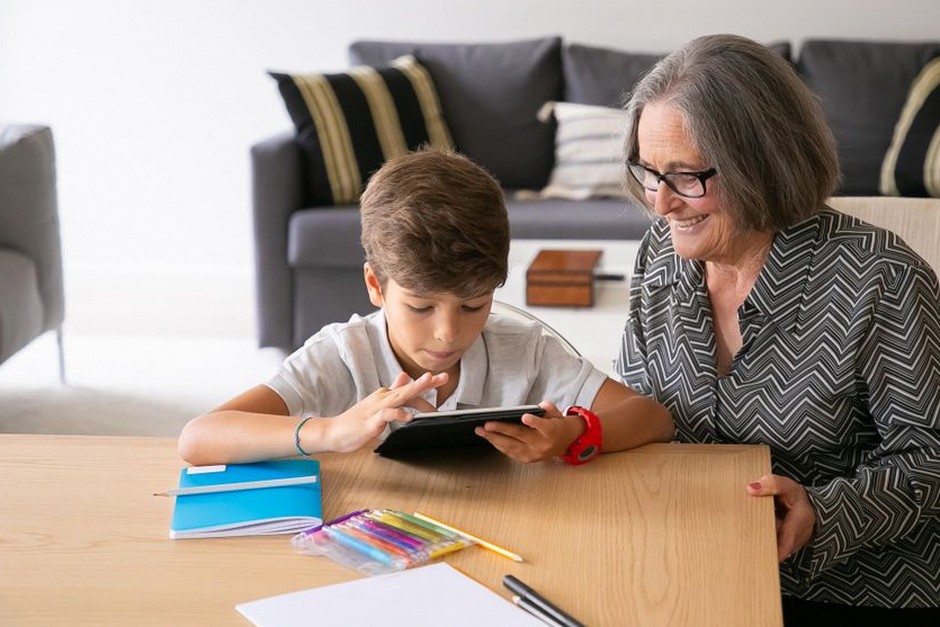 family helping grandmother with technology