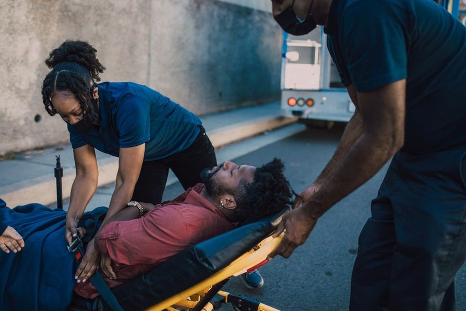 paramedics helping elderly patient