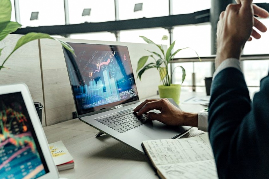 calm investor looking at laptop financial planning