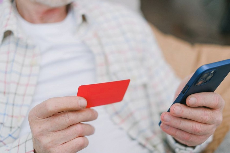 elderly person using smartphone banking app