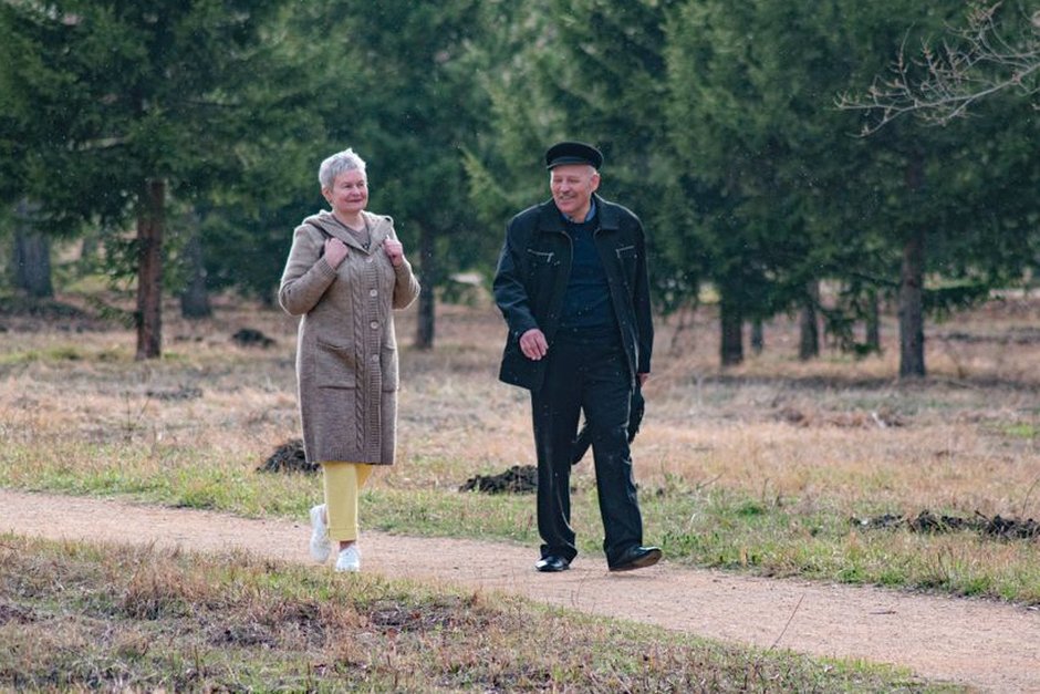 korean senior couple walking in park together