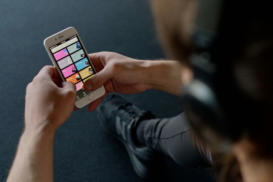 senior using smartphone music streaming app