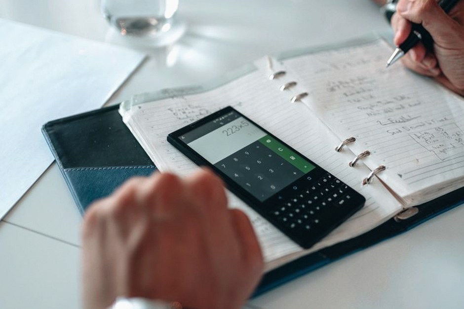 person planning finances notebook calculator