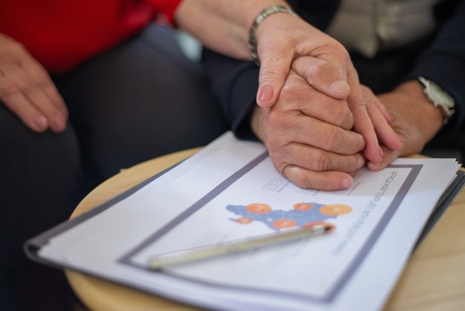 elderly hands holding documents