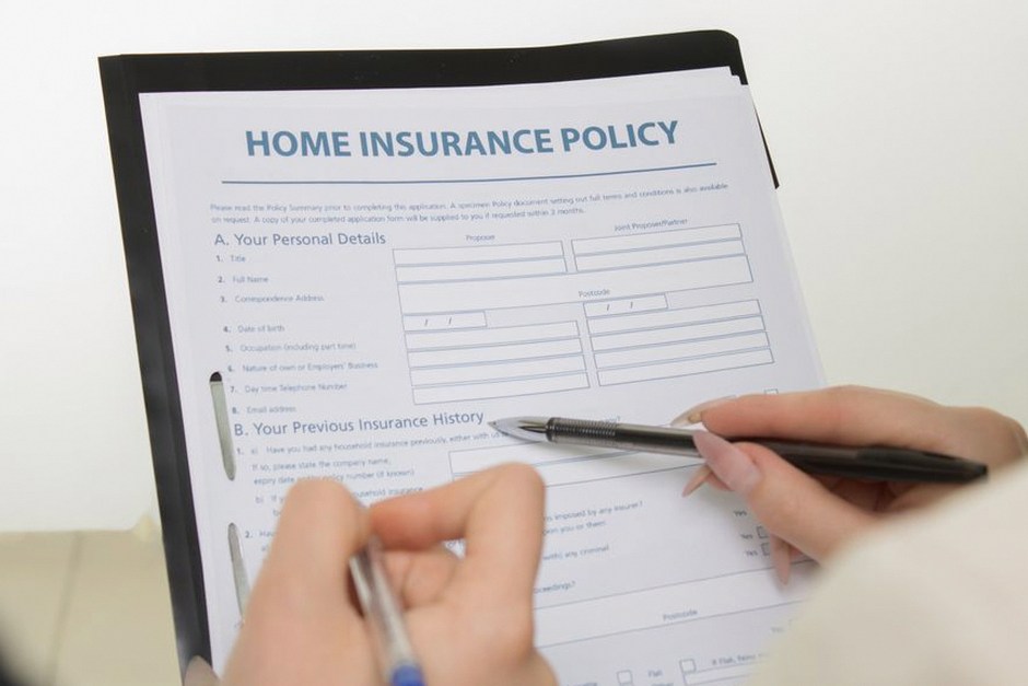 hands holding insurance policy folder