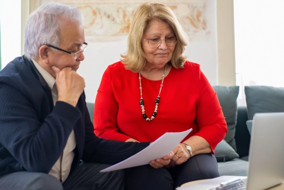 elderly couple reviewing finance documents