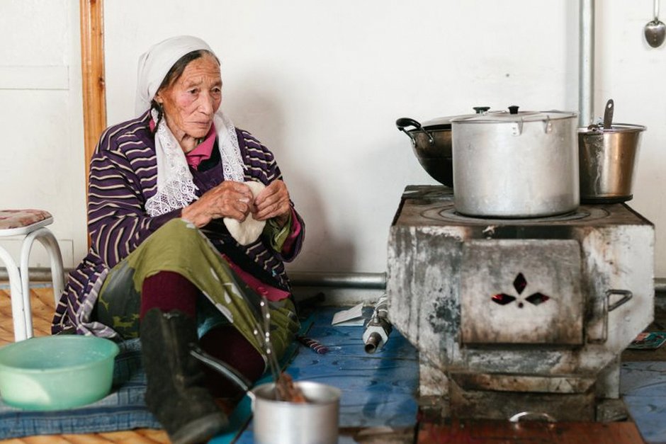 elderly Korean woman cooking in kitchen