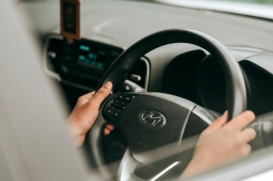 elderly hands on steering wheel
