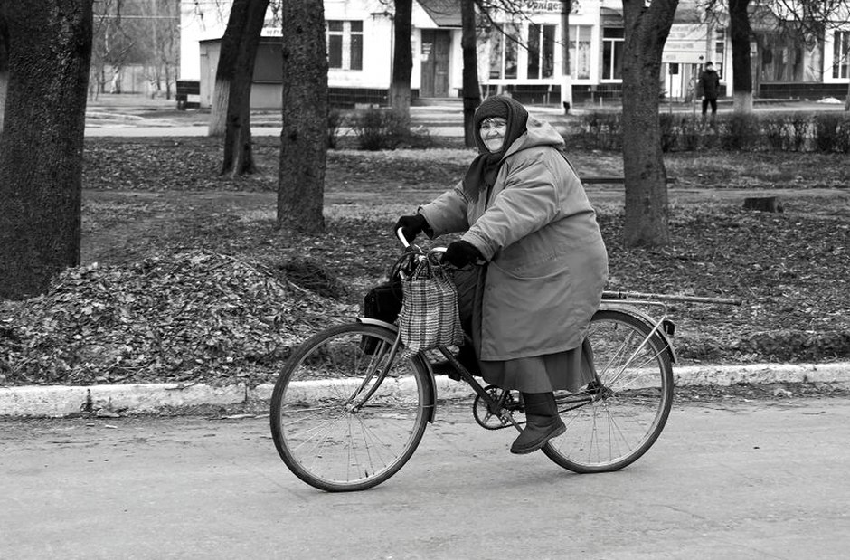 elderly cyclist evening street lights
