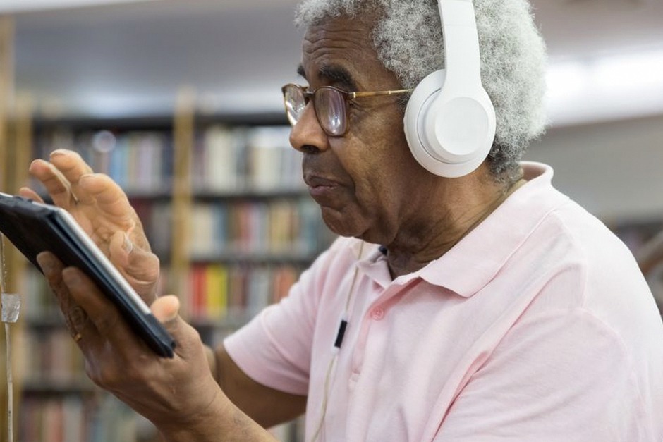 elderly person using tablet online learning
