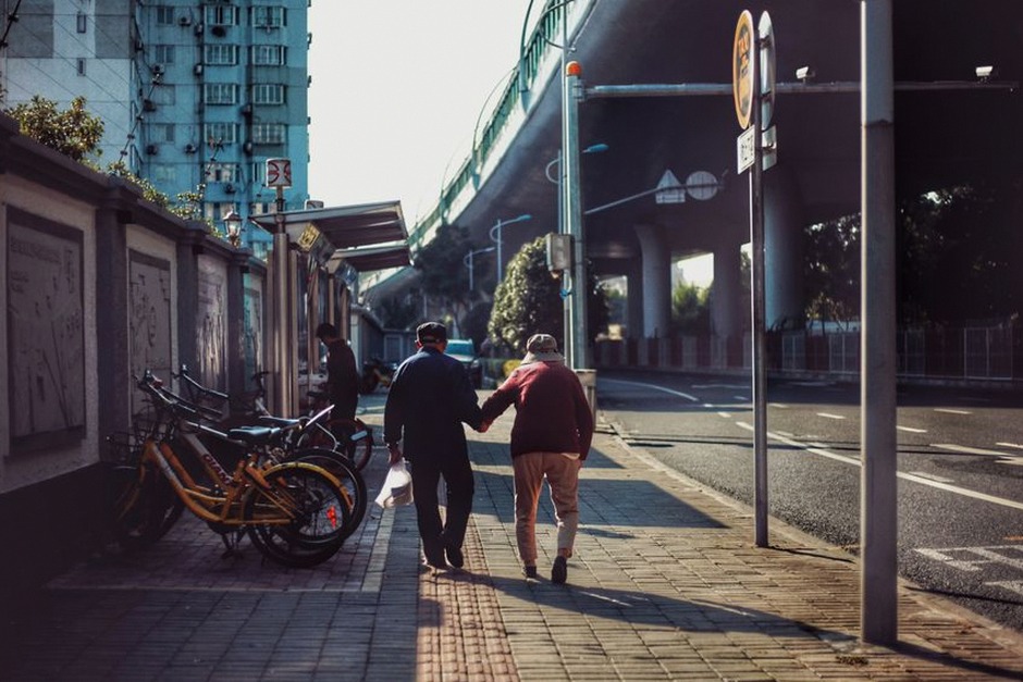 elderly couple walking public transportation