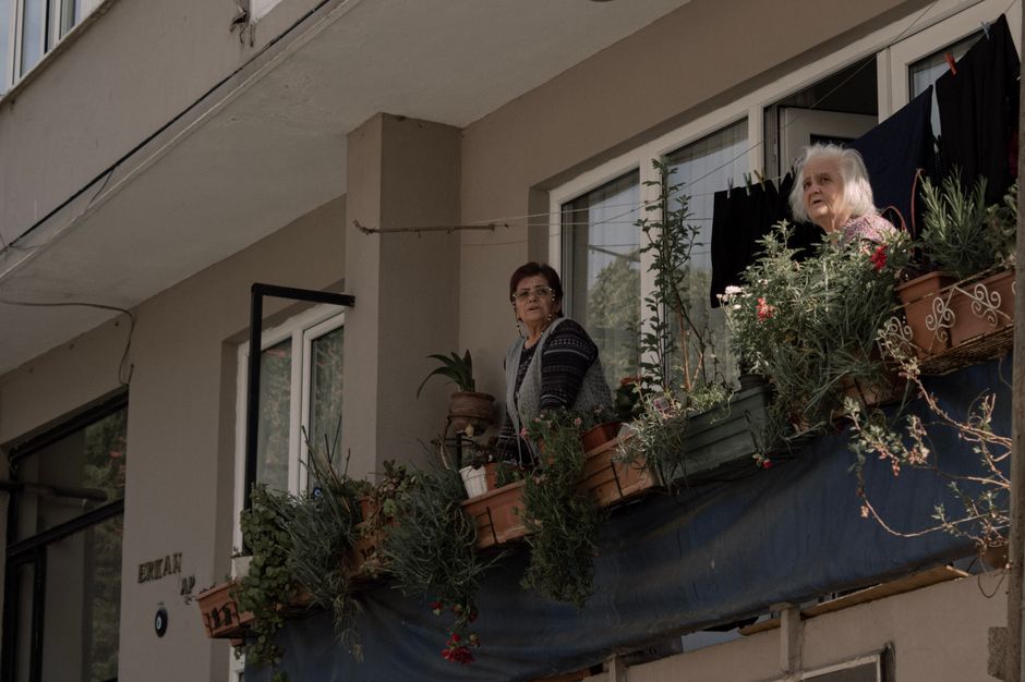 senior neighbors talking apartment courtyard