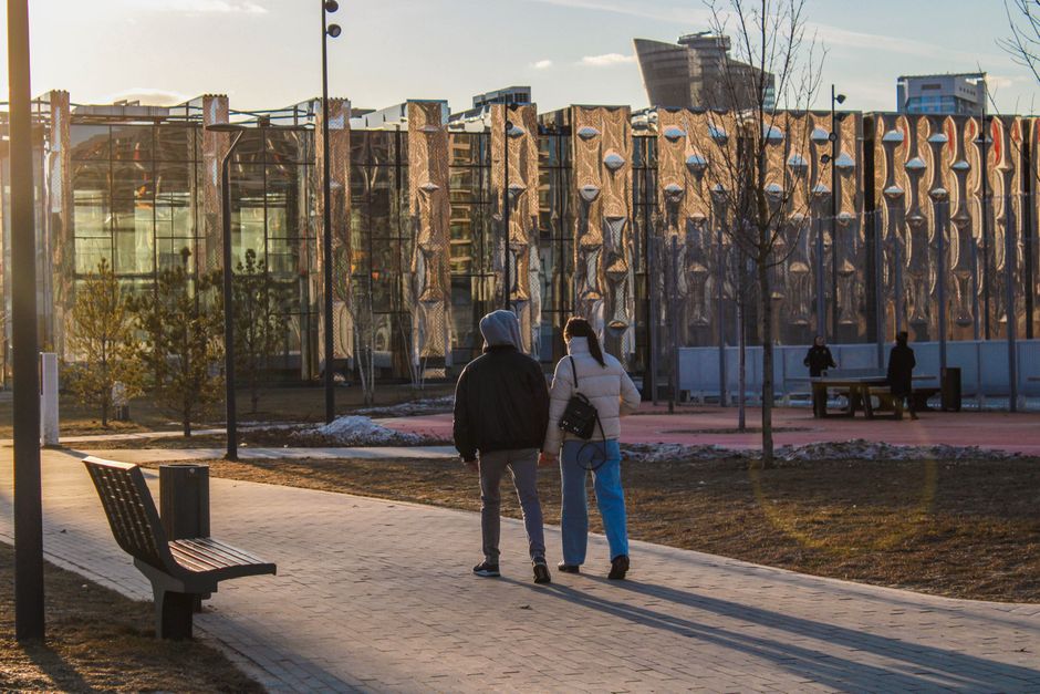 people walking in urban park evening