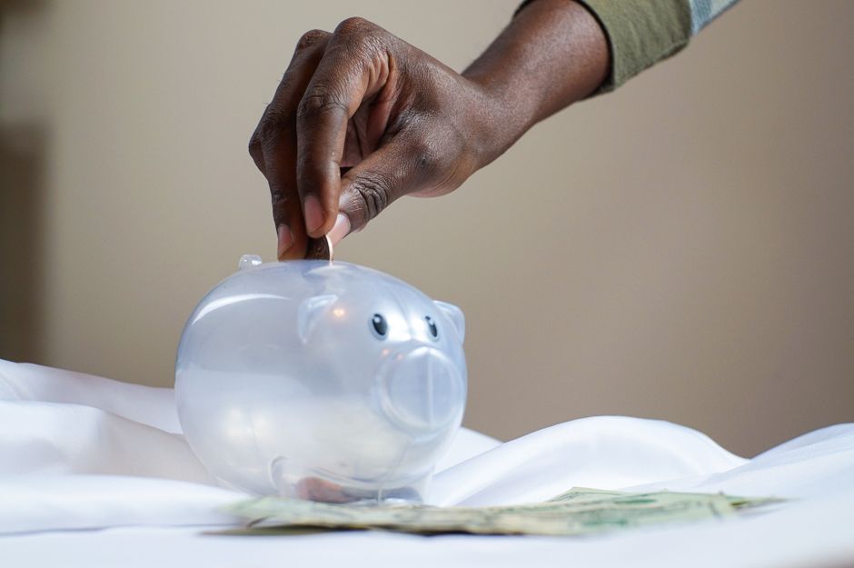 person saving money piggy bank