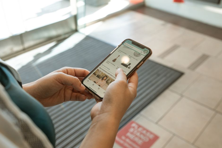 person looking at online shopping cart on phone