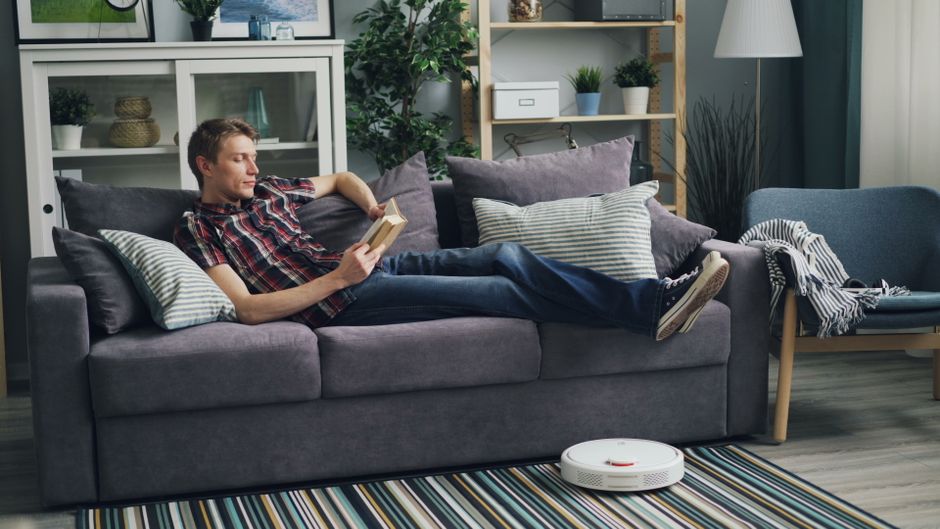elderly person living room robot vacuum