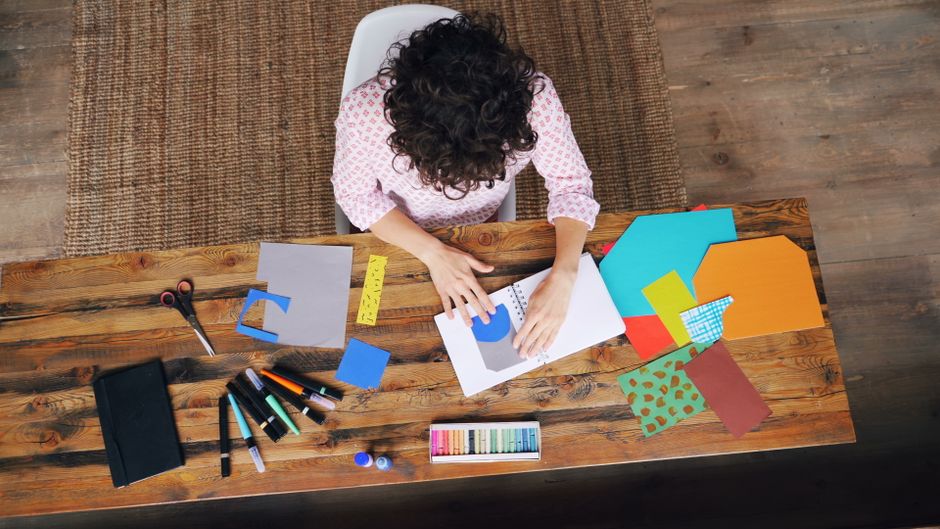 elderly woman doing paper craft at home